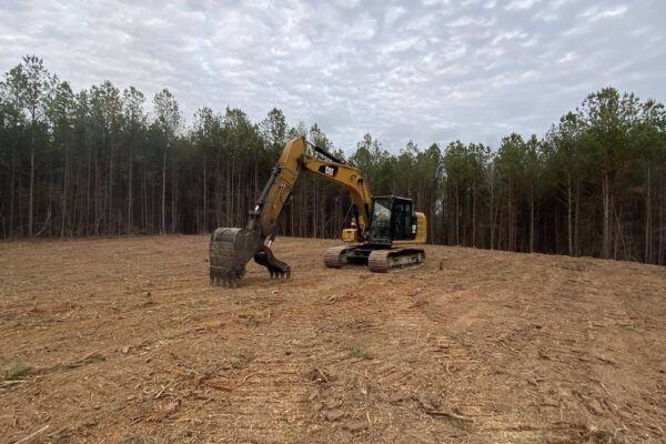 backhoe clearing land